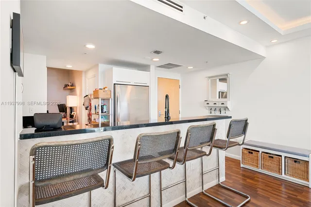 a bedroom with furniture and a flat screen tv