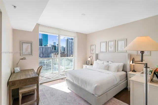 a bedroom with a bed and a large window