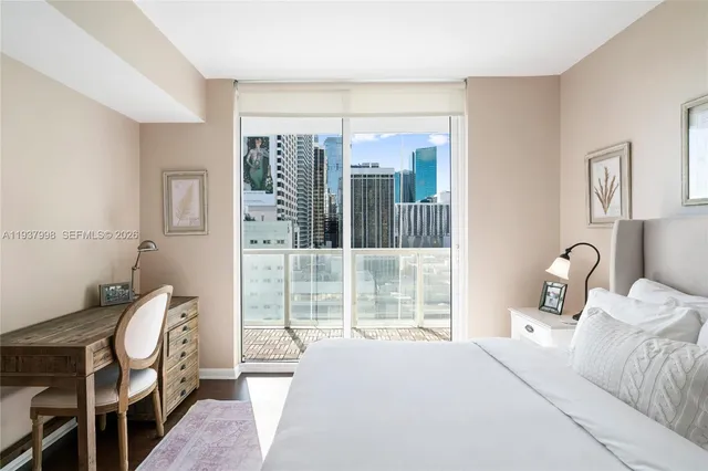a bathroom with a granite countertop sink a mirror and a shower