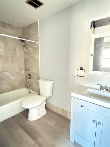 a bathroom with a toilet a sink and bathtub