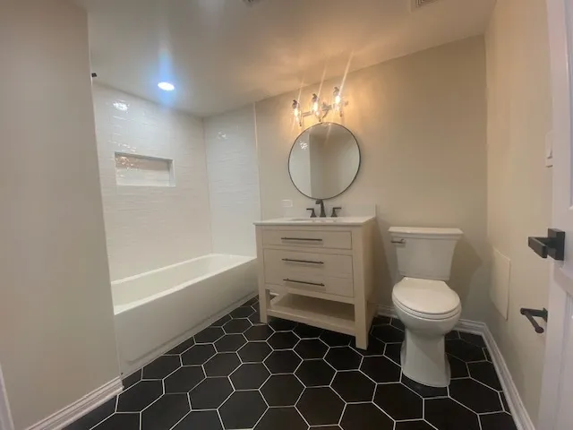 a bathroom with a toilet a sink and a mirror