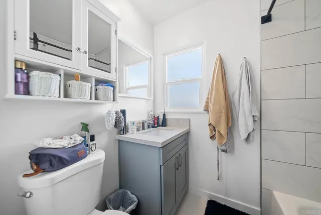 a bathroom with a sink toilet and shower