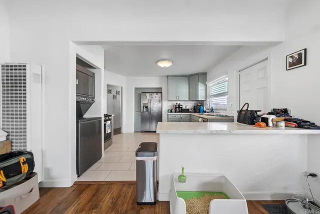 a kitchen with stainless steel appliances a refrigerator and a stove top oven