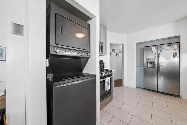 a kitchen with granite countertop a refrigerator and a stove