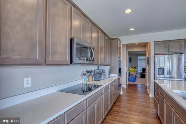 a kitchen with stainless steel appliances sink a microwave and cabinets