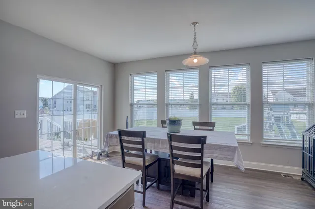 a view of a dining room with furniture wooden floor and chandelier