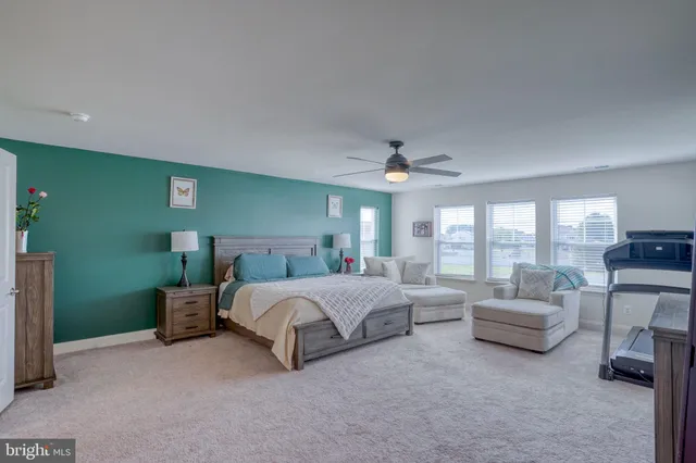 a spacious bedroom with a bed and a couch