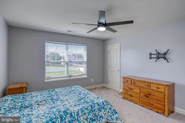 a bedroom with a bed dresser and a window