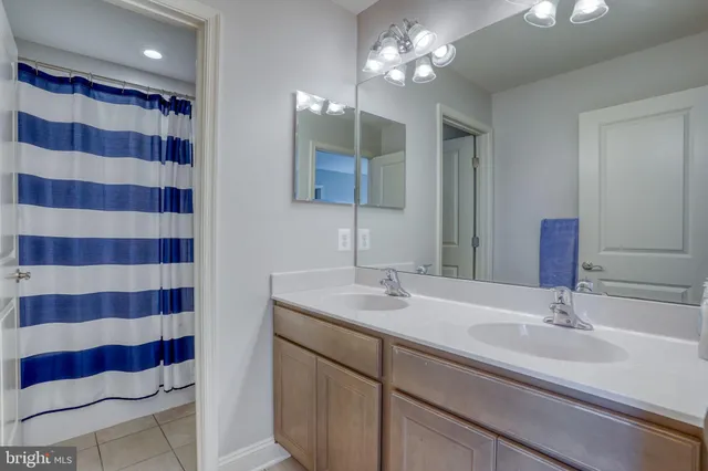 a bathroom with a sink a large mirror and a shower