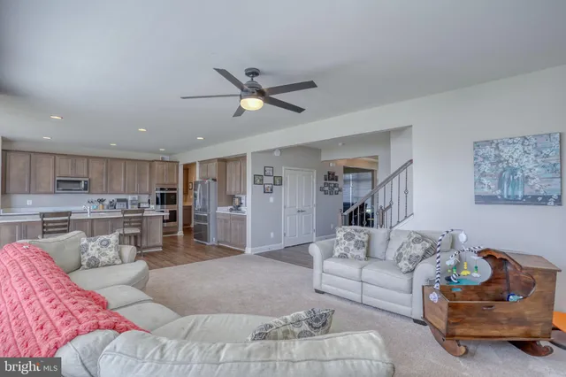 a living room with furniture and kitchen view