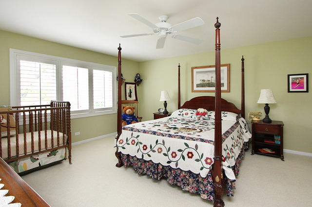 1760 Park Ridge Point, Unit 1760 Park Ridge, IL 60068 - Photo 14 of 15 a bedroom with a bed chandelier and a window