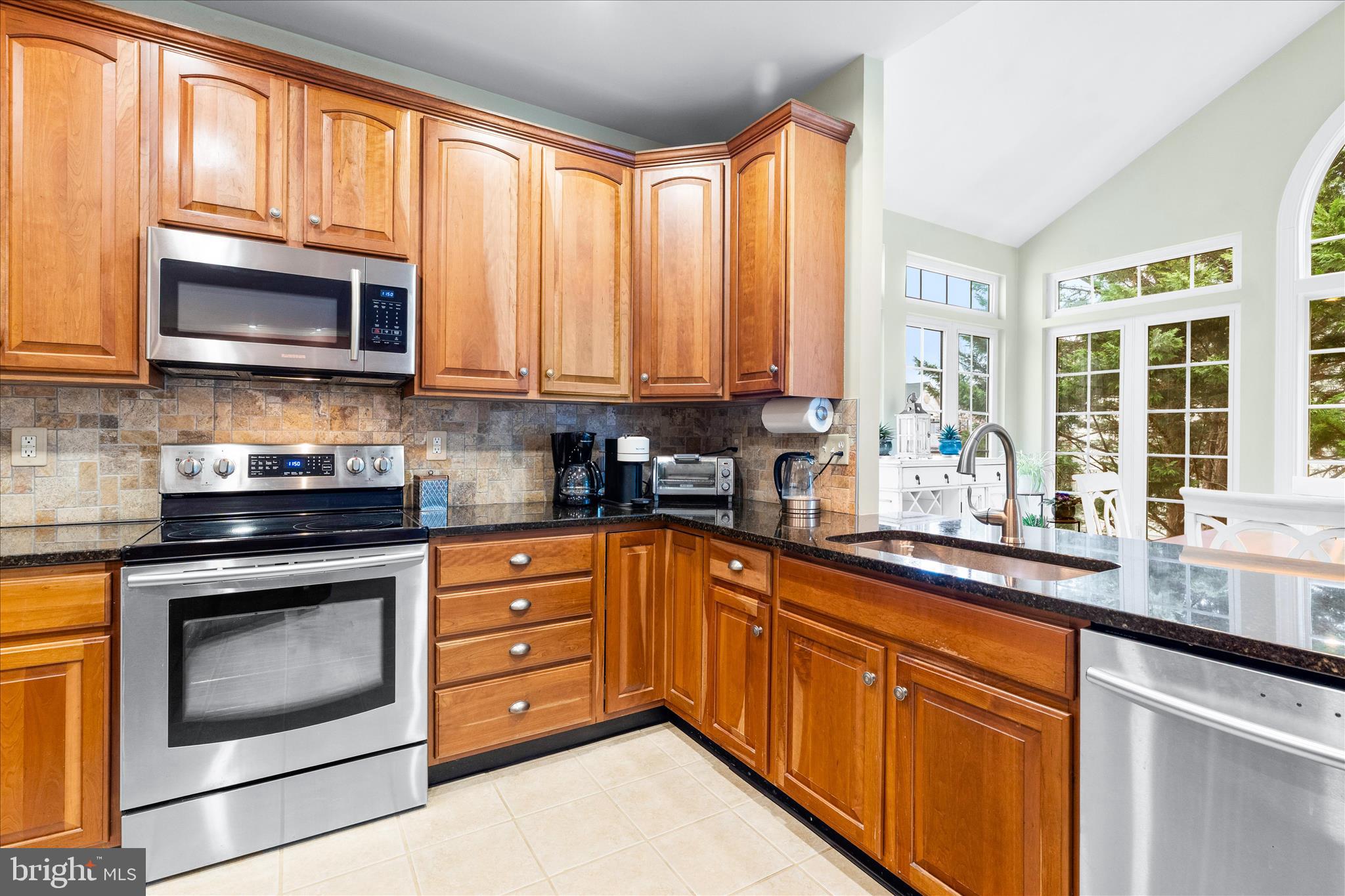 9054 Seward Street Frederick, MD 21704 - Photo 12 of 41 a kitchen with stainless steel appliances granite countertop a stove a sink and a microwave