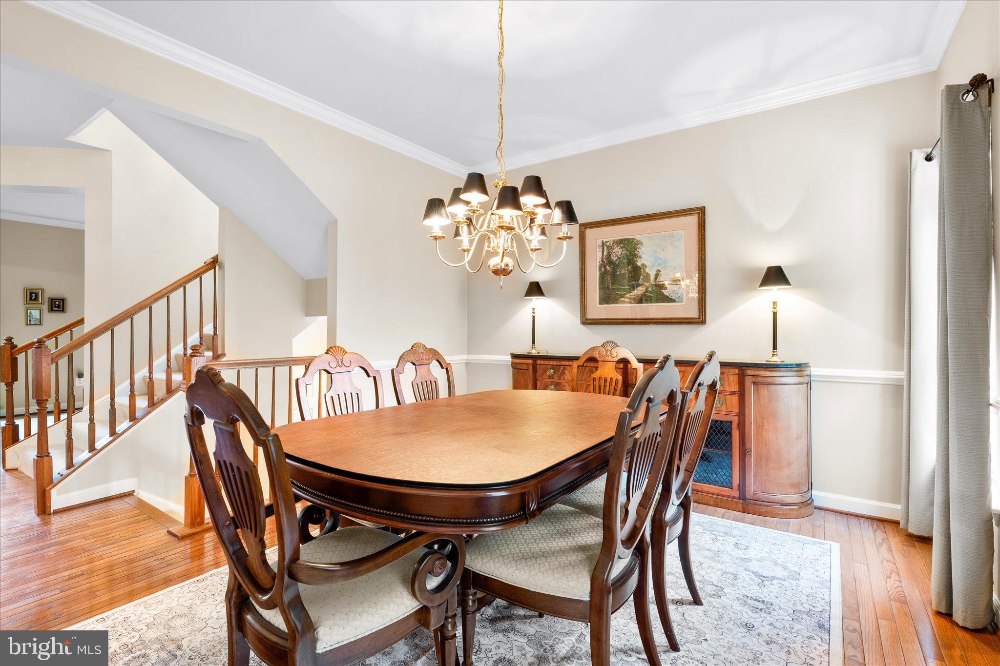 9054 Seward Street Frederick, MD 21704 - Photo 17 of 41 a dining room with furniture a chandelier and wooden floor