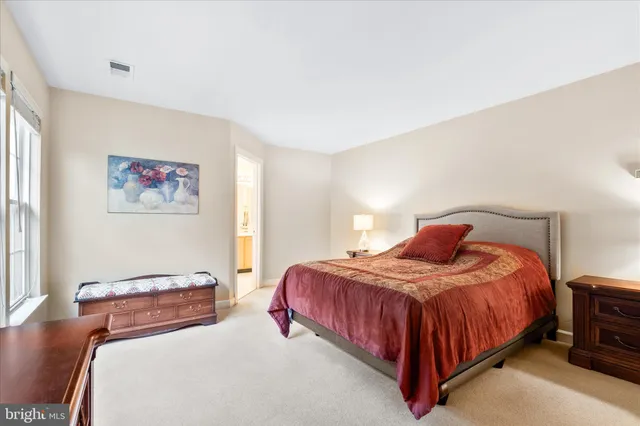 a bedroom with a bed and a night stand