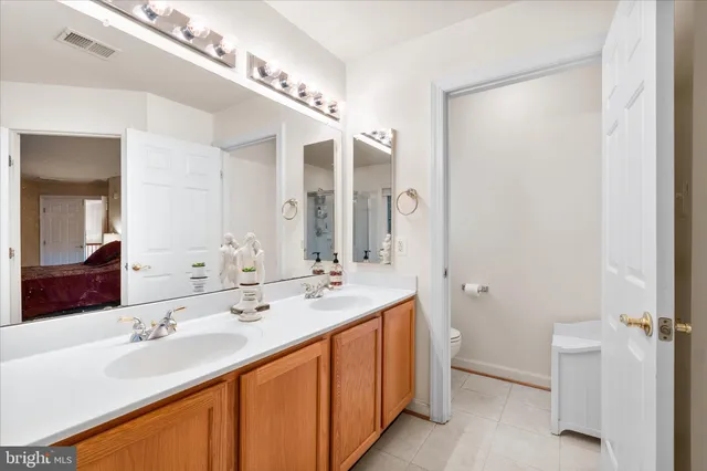 a bathroom with a double vanity sink and a mirror