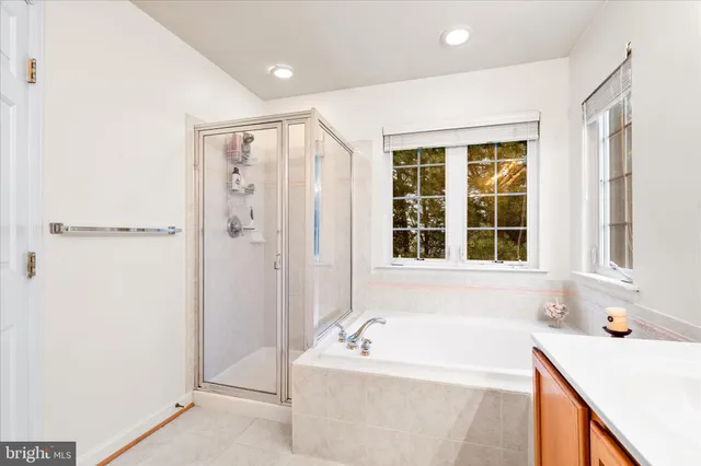 a bathroom with a tub sink and a shower