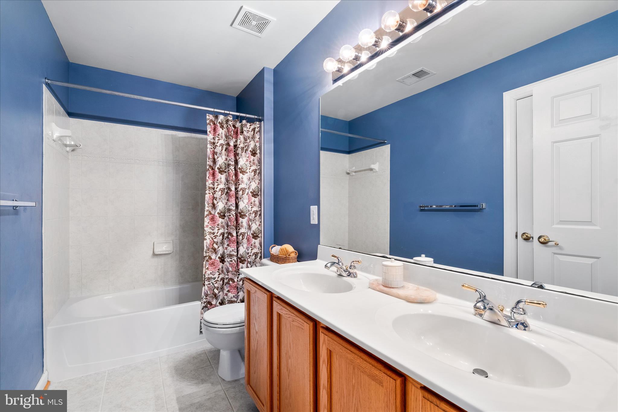 9054 Seward Street Frederick, MD 21704 - Photo 29 of 41 a bathroom with a double vanity sink toilet and shower