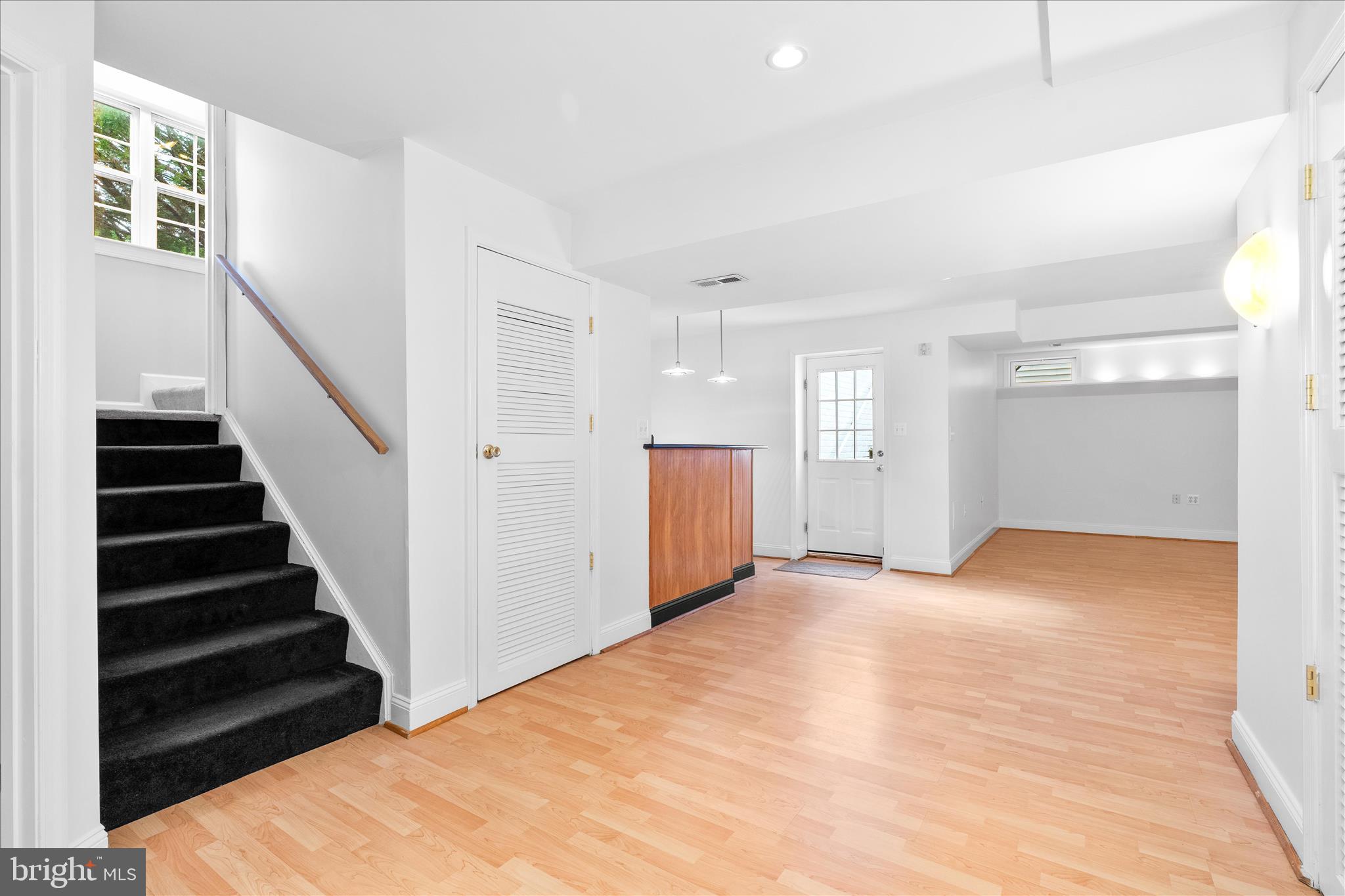 9054 Seward Street Frederick, MD 21704 - Photo 30 of 41 a view of an empty room with wooden floor and stairs