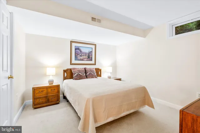 a bedroom with a bed and a wall painting