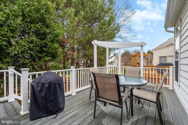 a view of a deck with table and chairs and wooden floor