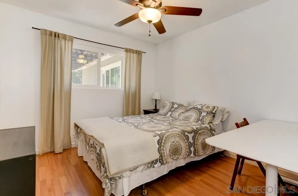 4925 Rebel Road San Diego, CA 92117 - Photo 15 of 25 a bedroom with a bed and a chandelier