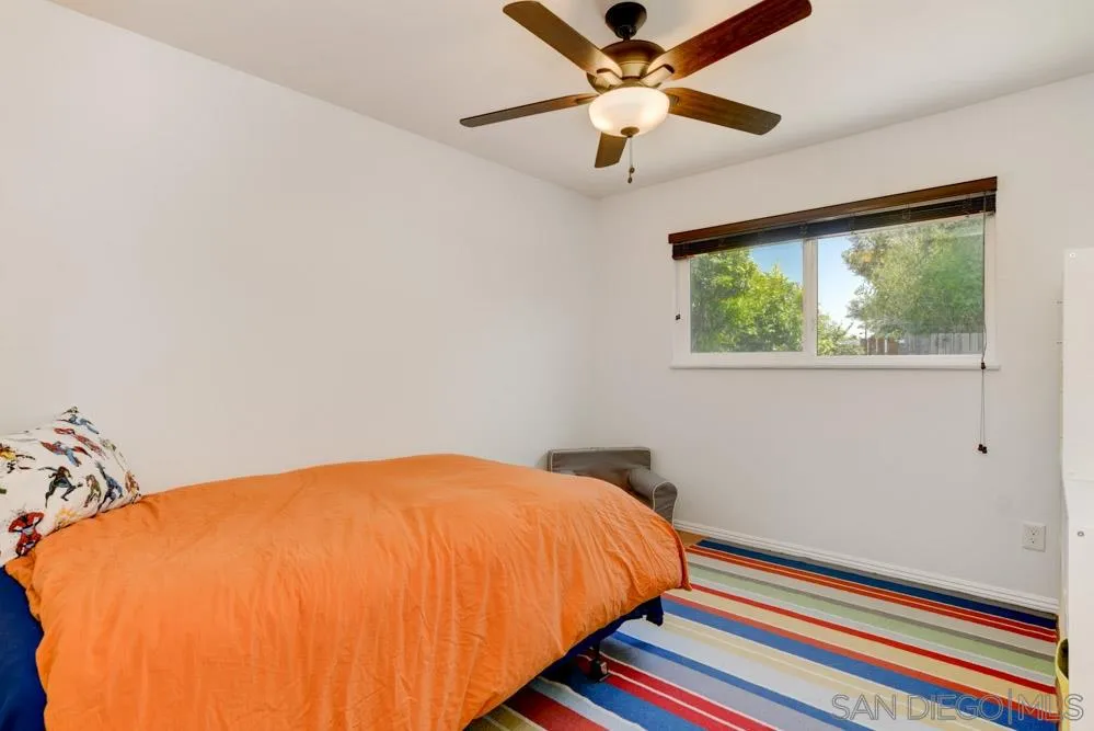 4925 Rebel Road San Diego, CA 92117 - Photo 16 of 25 a bed sitting in a bedroom next to a window