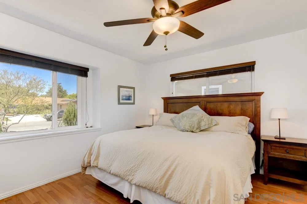 4925 Rebel Road San Diego, CA 92117 - Photo 17 of 25 a bedroom with a large bed and a large window
