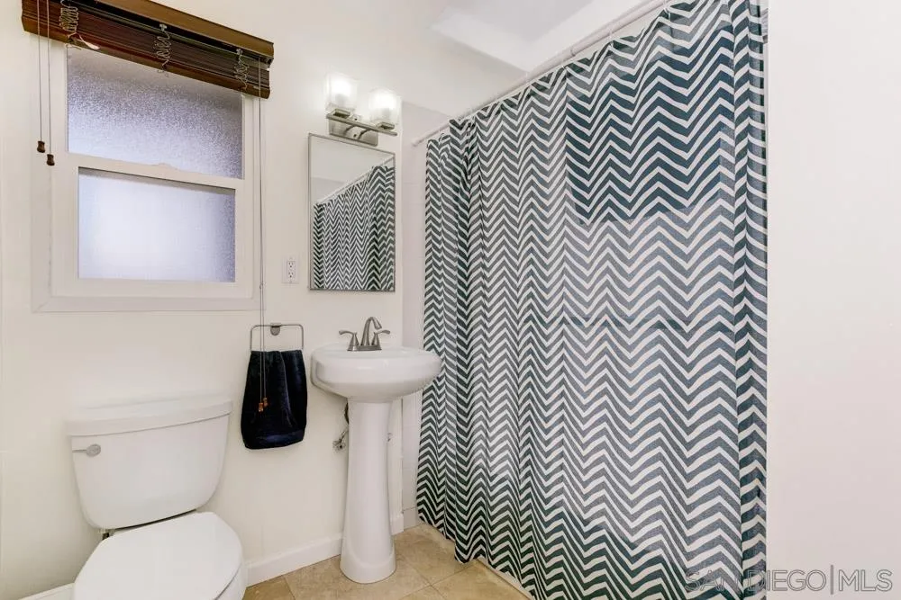 4925 Rebel Road San Diego, CA 92117 - Photo 18 of 25 a bathroom with a toilet and a sink