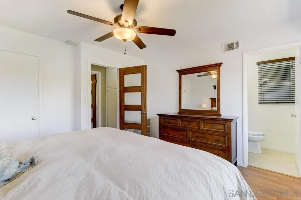 4925 Rebel Road San Diego, CA 92117 - Photo 19 of 25 a bedroom with a bed and a dresser