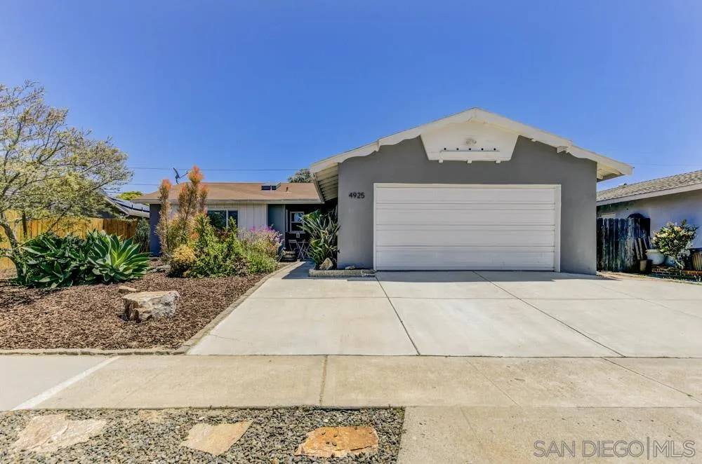 4925 Rebel Road San Diego, CA 92117 - Photo 2 of 25 a front view of a house with a garage