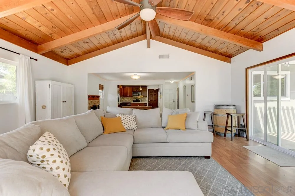 4925 Rebel Road San Diego, CA 92117 - Photo 3 of 25 a living room with furniture and a chandelier