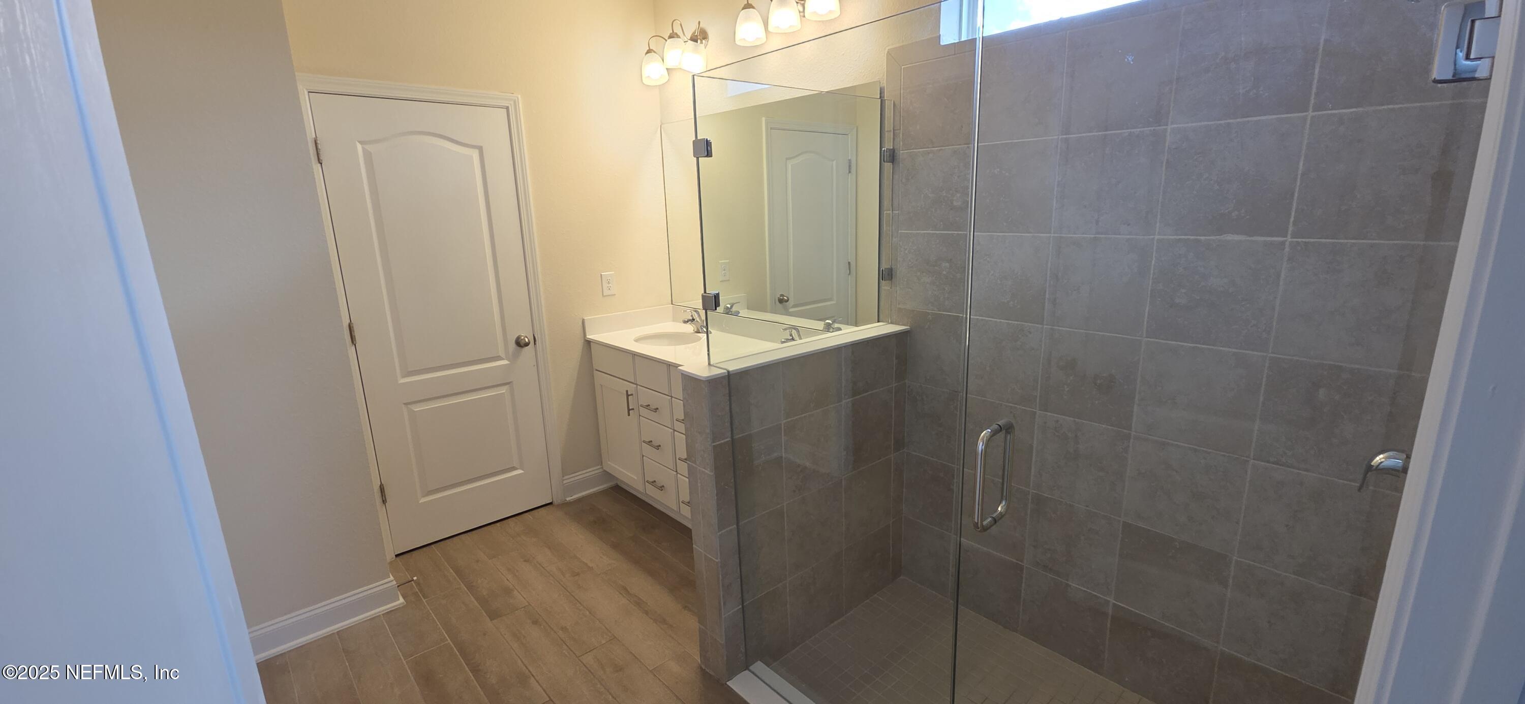 228 Thistleton Way Street St. Augustine, FL 32092 - Photo 11 of 25 a bathroom with a shower and sink