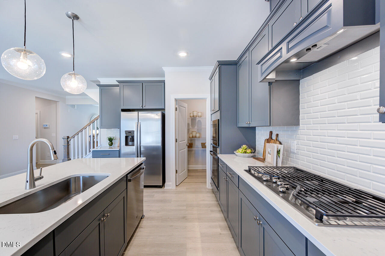1112 Sun Spgs Road Wake Forest, NC 27587 - Photo 11 of 44 a kitchen with stainless steel appliances granite countertop a sink stove and refrigerator