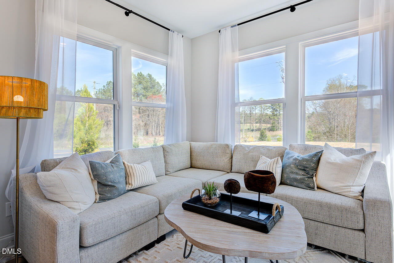 1112 Sun Spgs Road Wake Forest, NC 27587 - Photo 18 of 44 a living room with furniture and a large window