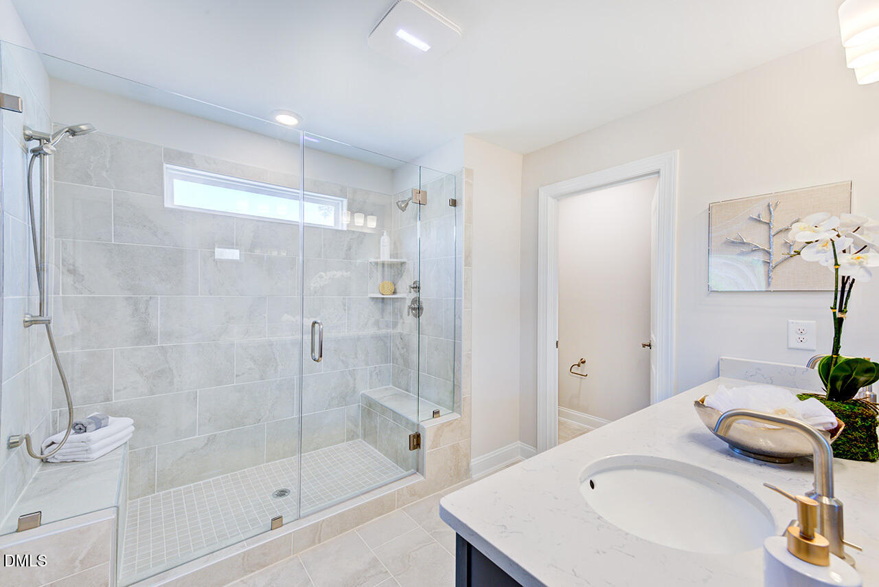 1112 Sun Spgs Road Wake Forest, NC 27587 - Photo 22 of 44 a bathroom with a granite countertop sink a toilet and shower