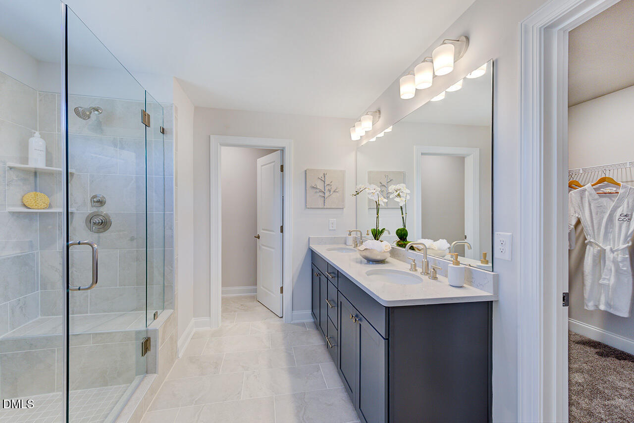 1112 Sun Spgs Road Wake Forest, NC 27587 - Photo 24 of 44 a bathroom with a double vanity sink mirror and shower