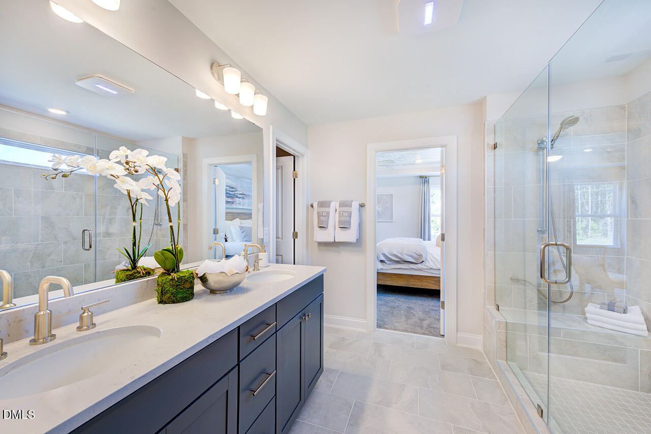 1112 Sun Spgs Road Wake Forest, NC 27587 - Photo 25 of 44 a en suite bathroom with a double sink and shower