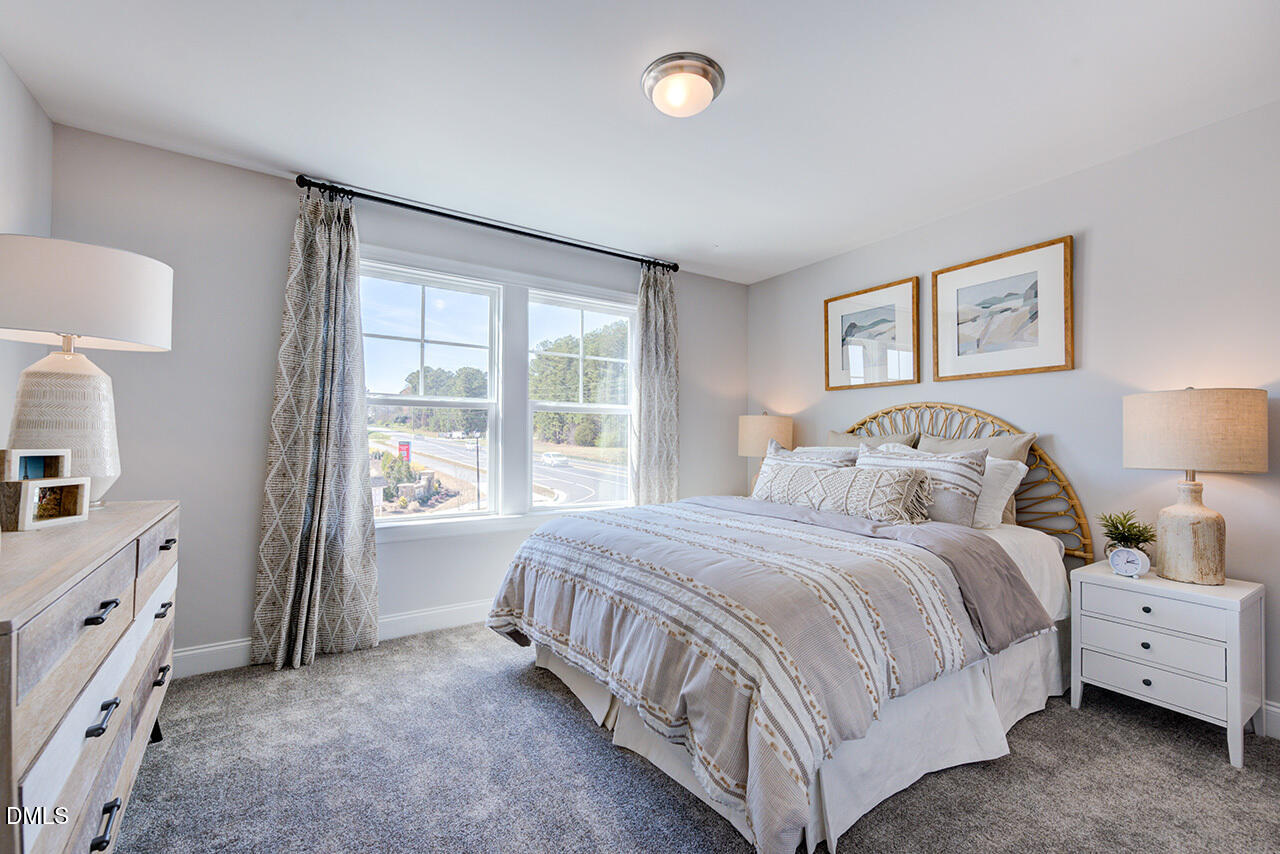 1112 Sun Spgs Road Wake Forest, NC 27587 - Photo 29 of 44 a spacious bedroom with a bed and a window