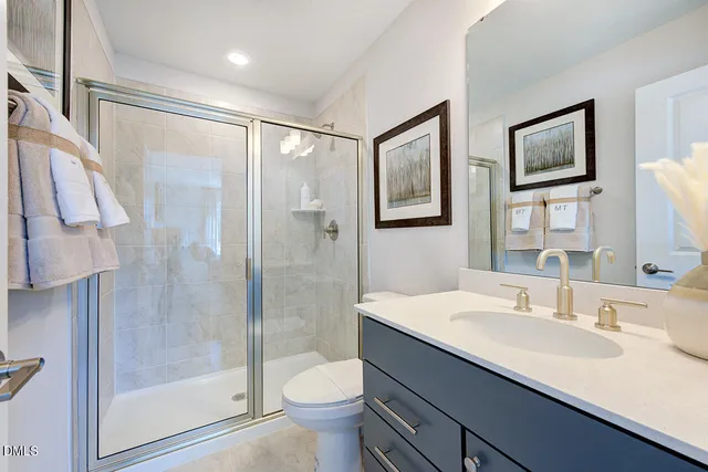 a bathroom with a shower and a glass door