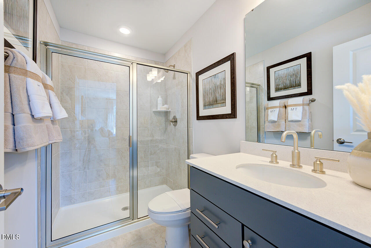 1112 Sun Spgs Road Wake Forest, NC 27587 - Photo 31 of 44 a bathroom with a granite countertop sink toilet and shower