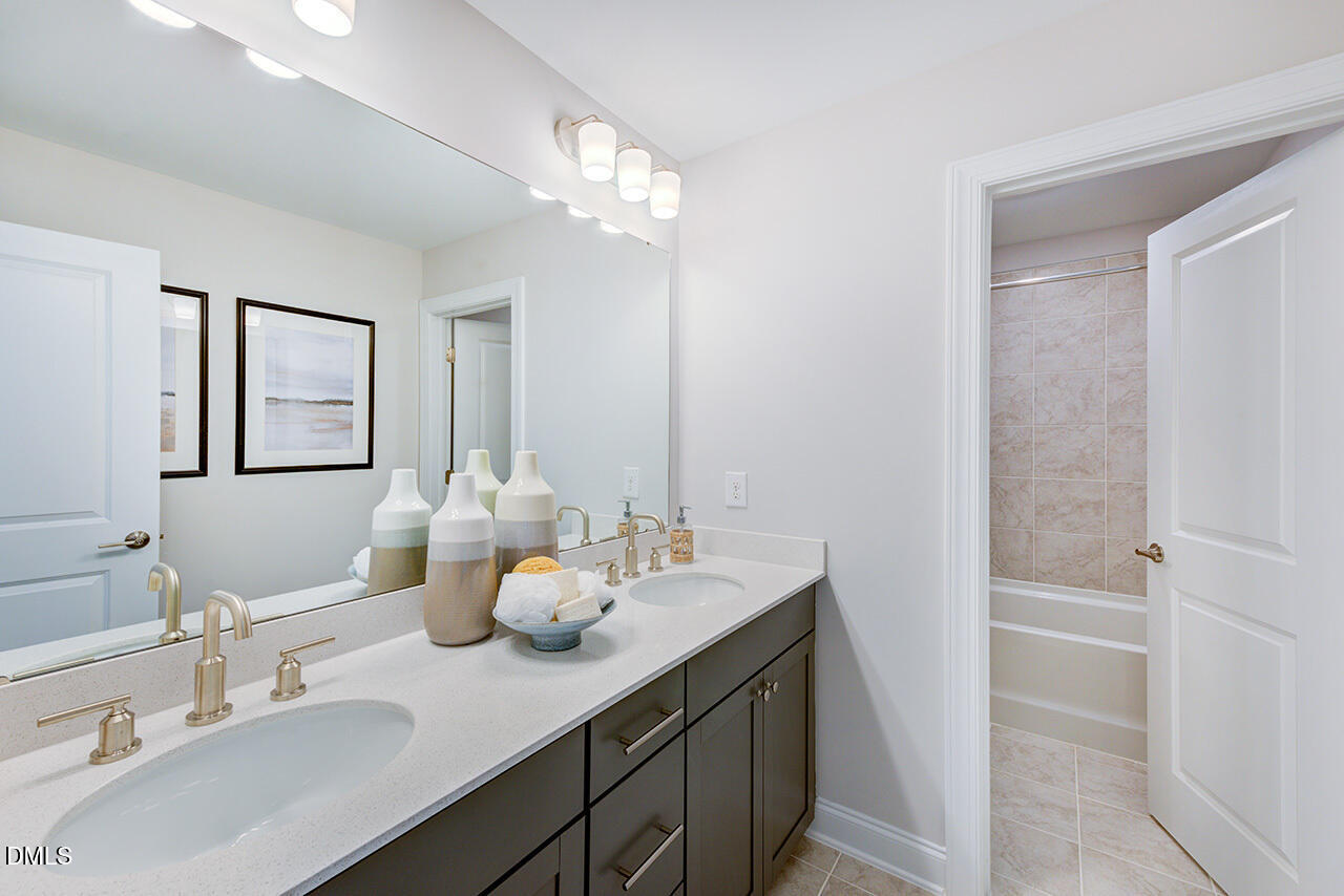 1112 Sun Spgs Road Wake Forest, NC 27587 - Photo 32 of 44 a bathroom with a double vanity sink and a mirror