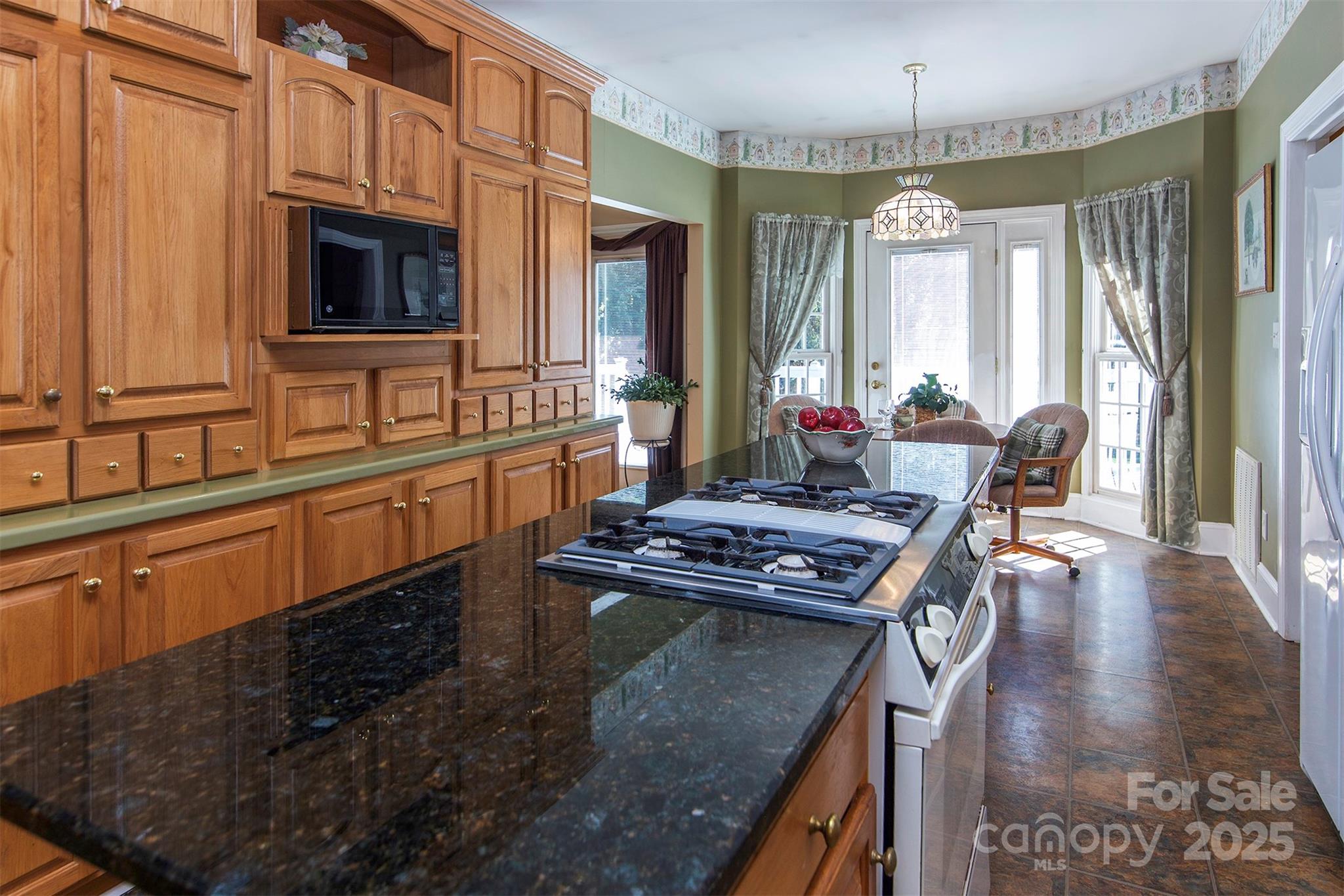1595 High Ridge Drive Stanley, NC 28164 - Photo 11 of 32 a kitchen with sink stove and chairs