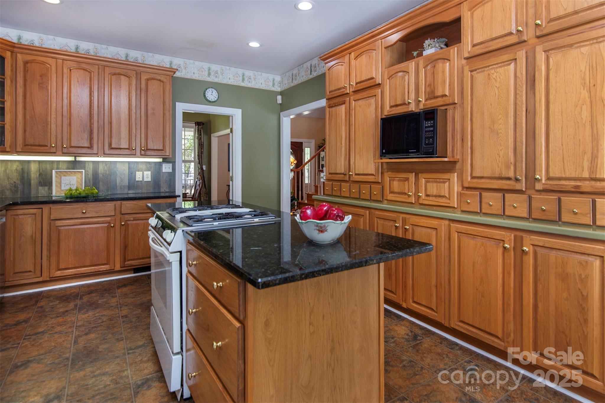 1595 High Ridge Drive Stanley, NC 28164 - Photo 12 of 32 a kitchen with stainless steel appliances granite countertop a sink stove and cabinets