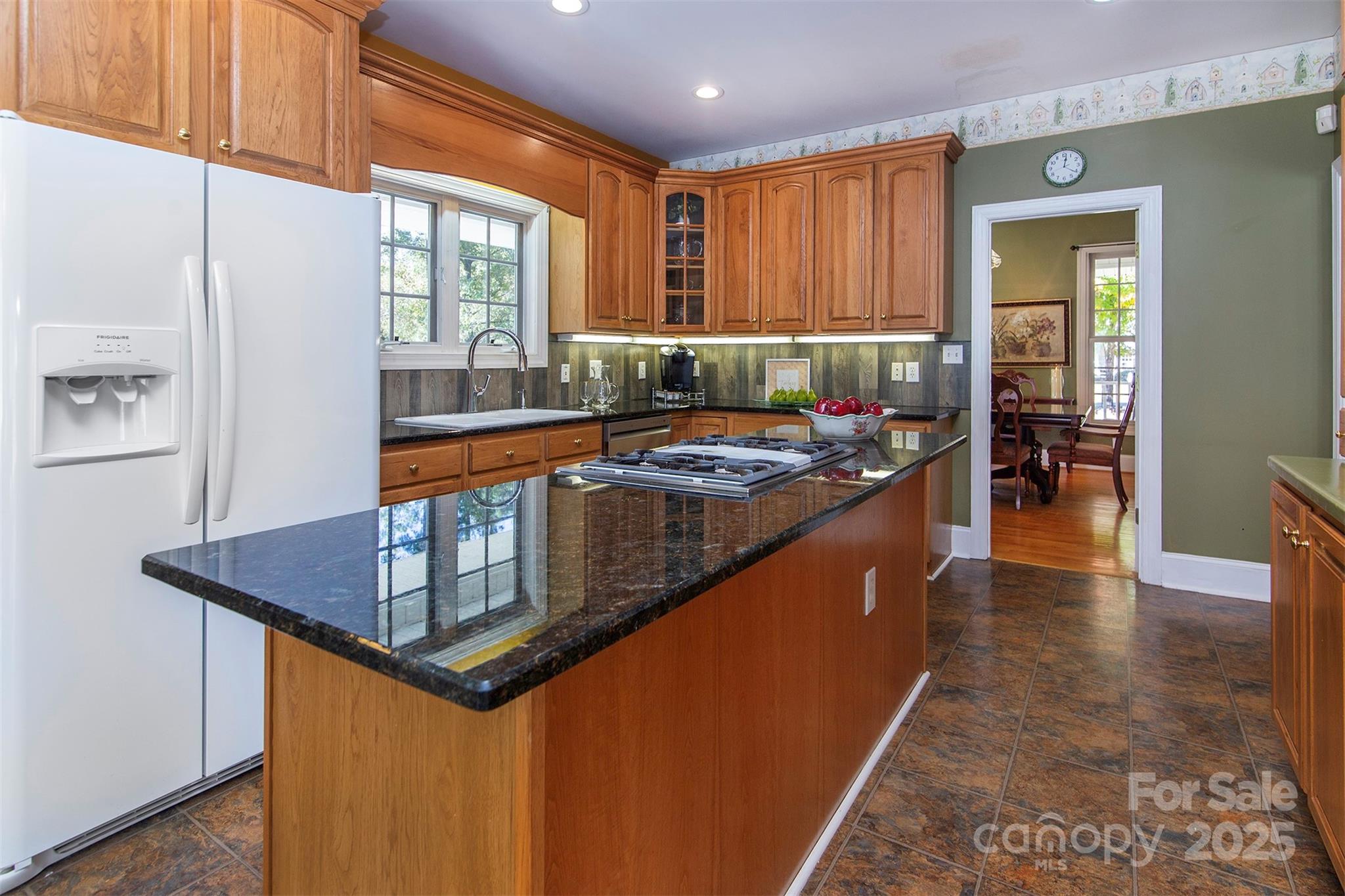 1595 High Ridge Drive Stanley, NC 28164 - Photo 14 of 32 a kitchen with stainless steel appliances granite countertop a stove a sink and a refrigerator
