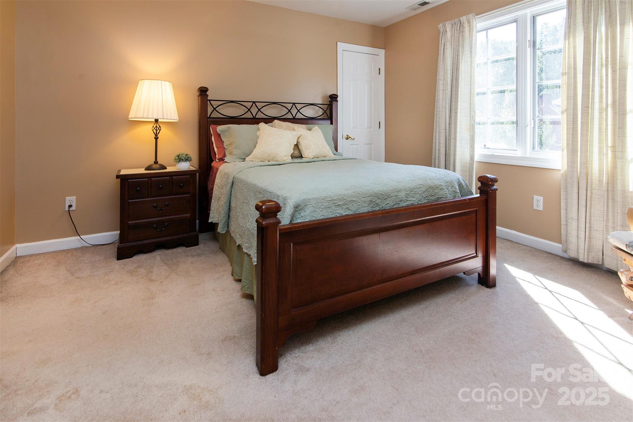 1595 High Ridge Drive Stanley, NC 28164 - Photo 25 of 32 a bed sitting in a bedroom next to a lamp