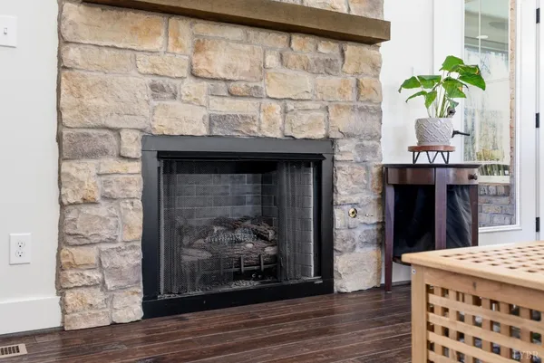 a front view of a house with a yard and large trees
