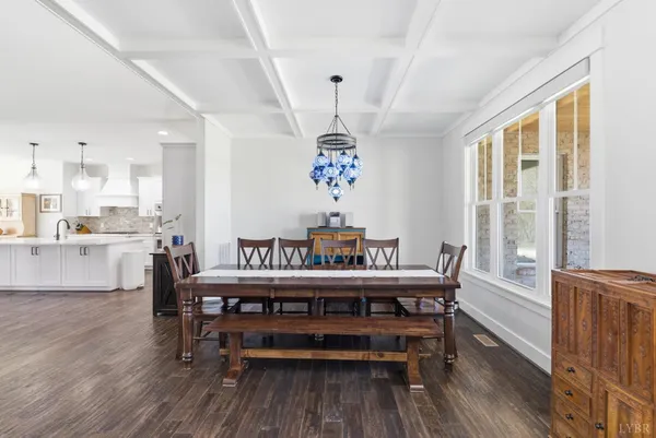 a view of a hallway with wooden floor and a bathroom