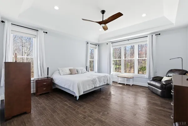 a view of a workspace with furniture and wooden floor