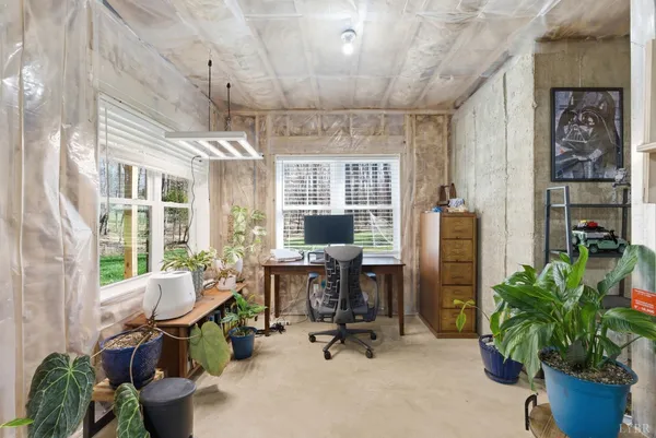a spacious bedroom with a bed and a ceiling fan