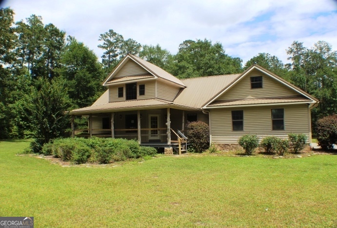 446 Highway 338 Dublin, GA 31021 - Photo 1 of 1 a front view of house with yard and green space